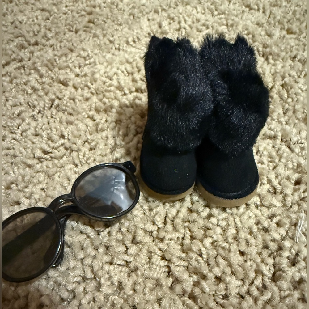 Labubu accessories: black shearling boot with zipper, and black glasses